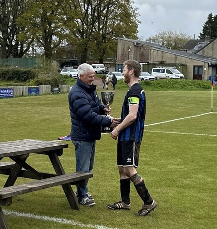 Bradley Willetts receives the trophy